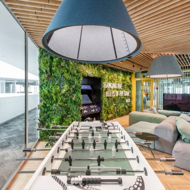 Indoor artificial green walls by football table
