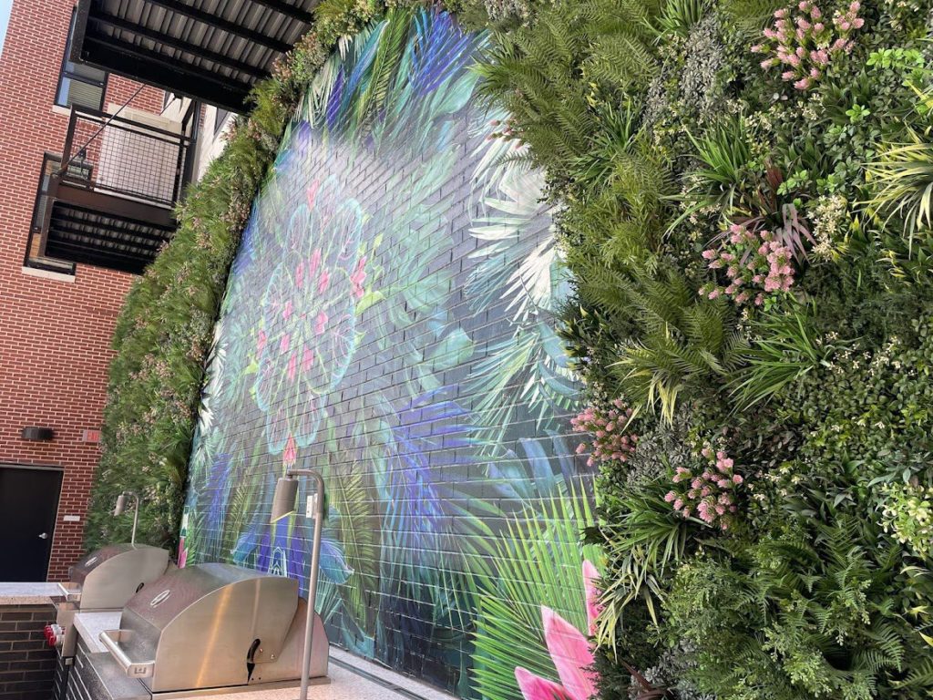 artificial living wall around colourful artwork