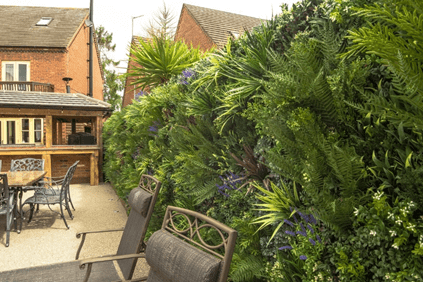 Artificial green walls for fences in garden dining area