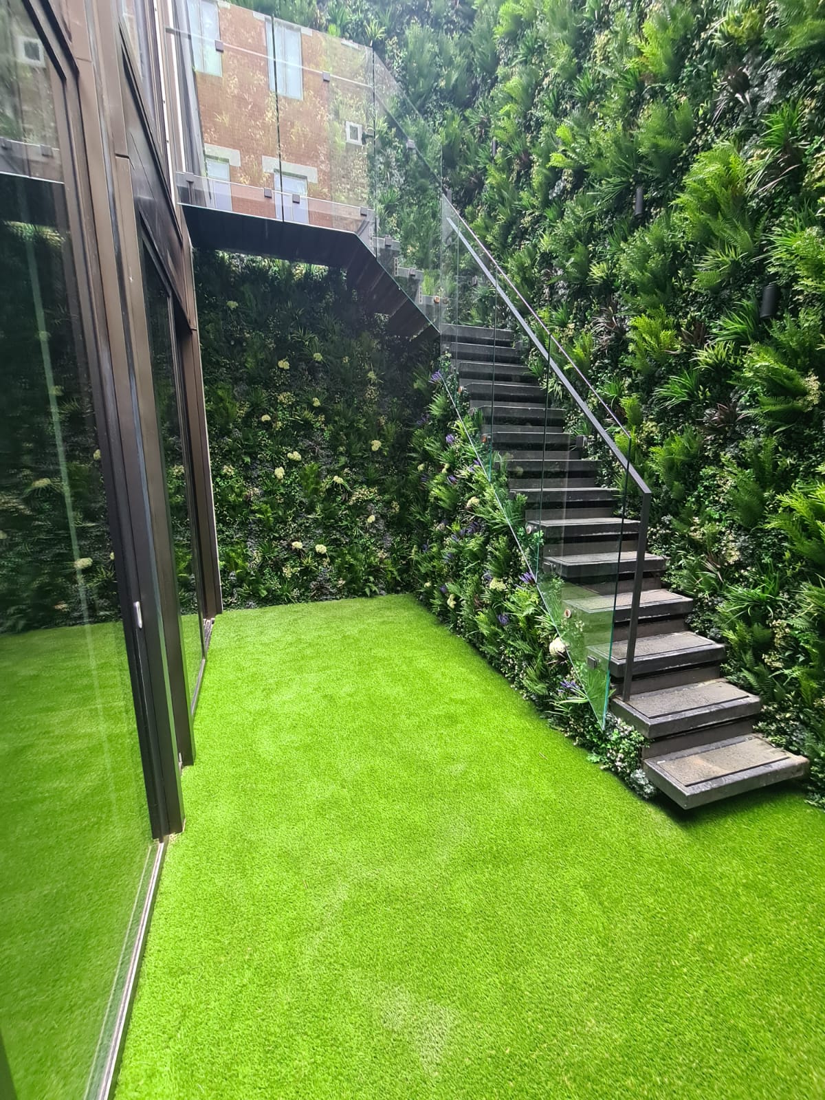 Basement staircase, surrounded by Artificial Green Wall