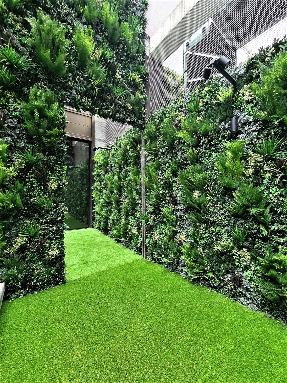 mirror installation within artificial Green wall