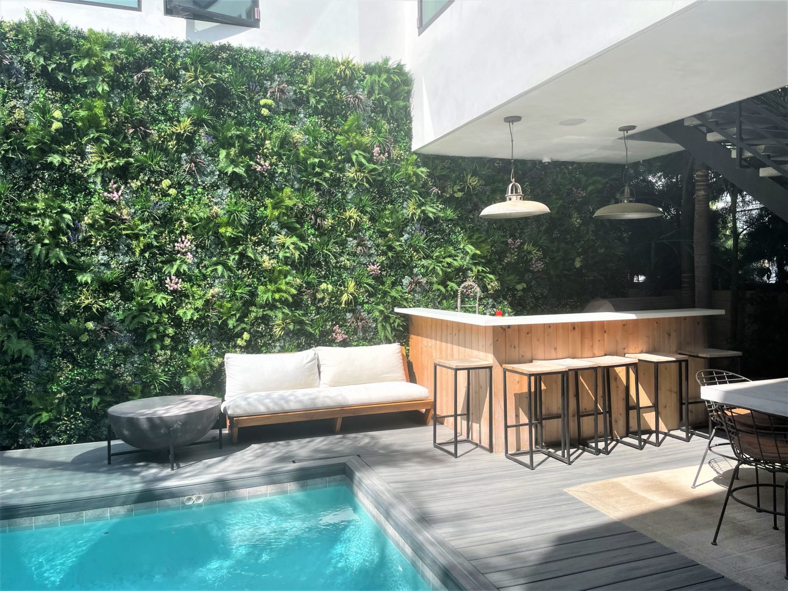 faux green wall installation by a swimming pool in California