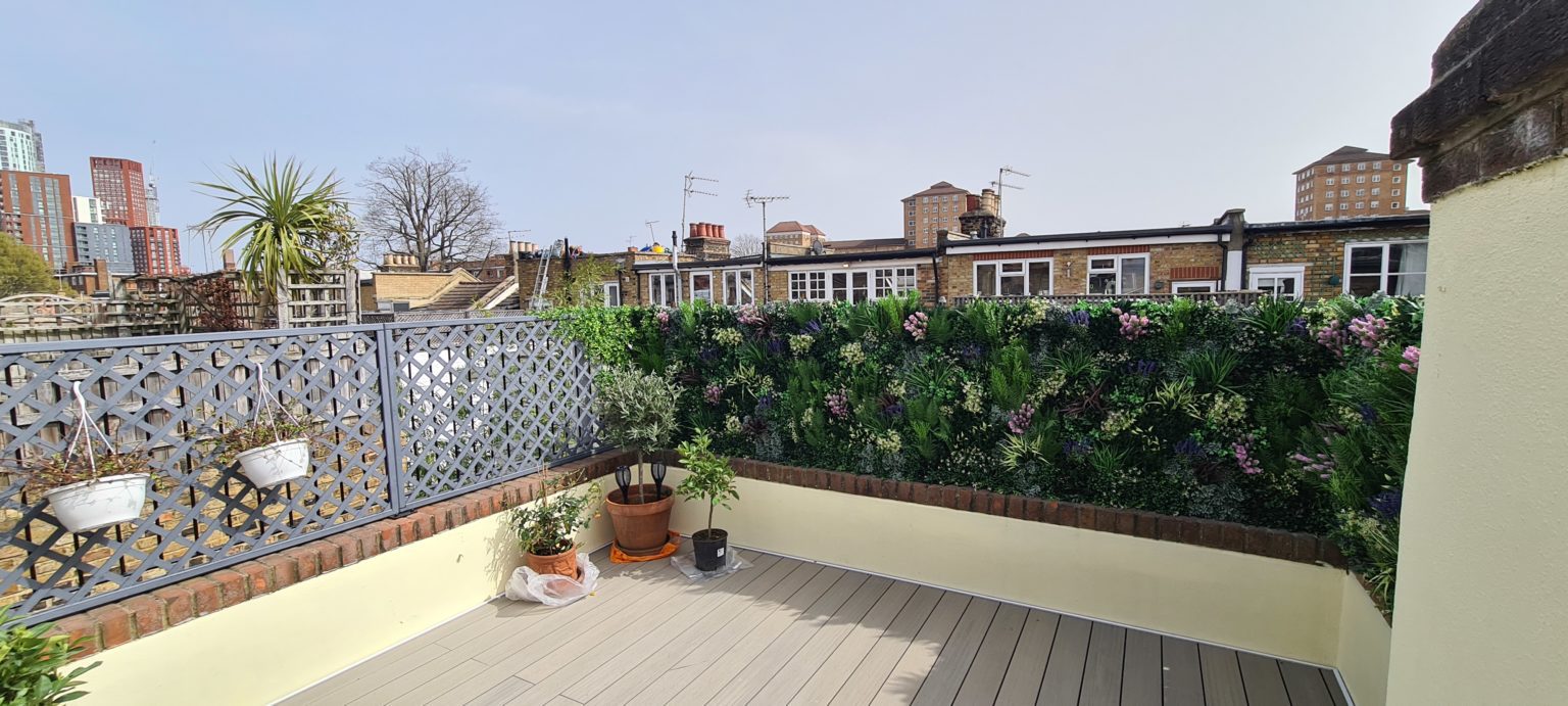 An artificial green wall installation by Vistafolia on a London roof terrace