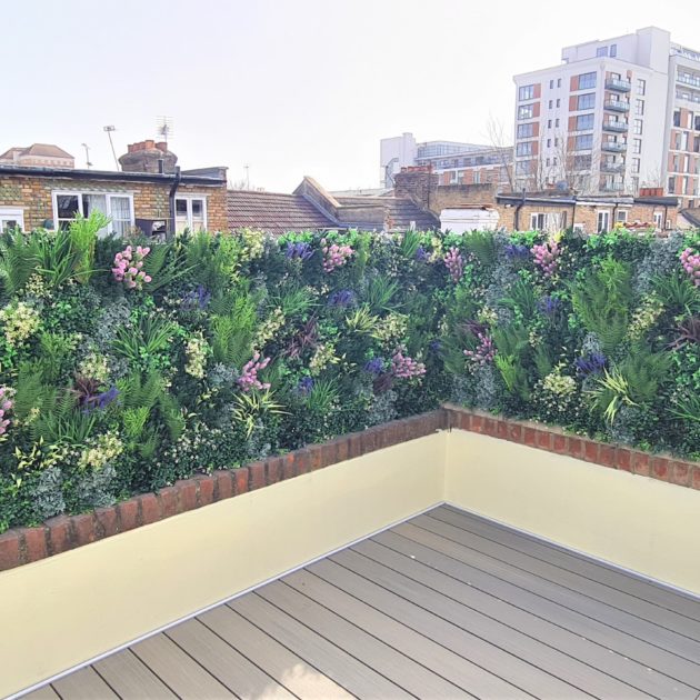 A faux green wall installation by Vistafolia on a London roof terrace