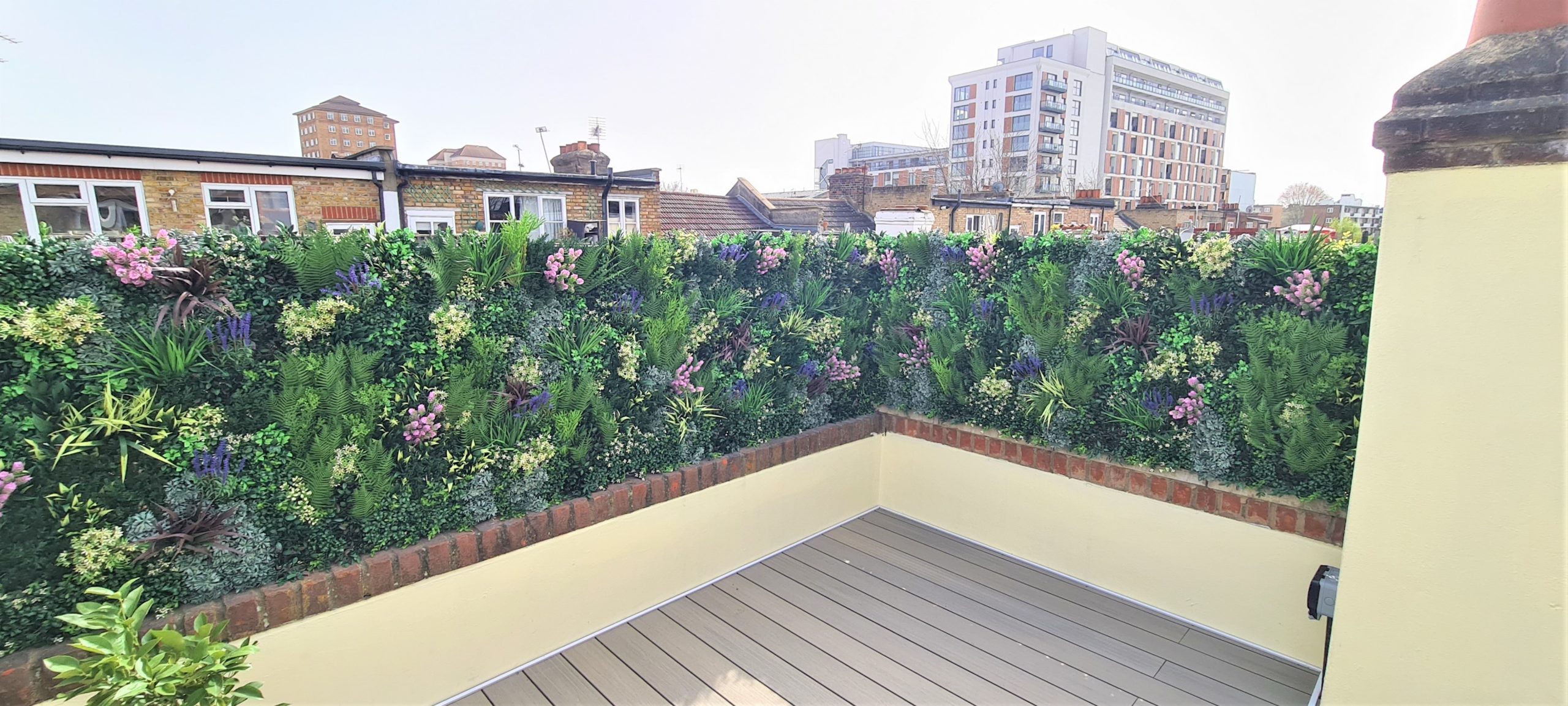 A faux green wall installation by Vistafolia on a London roof terrace