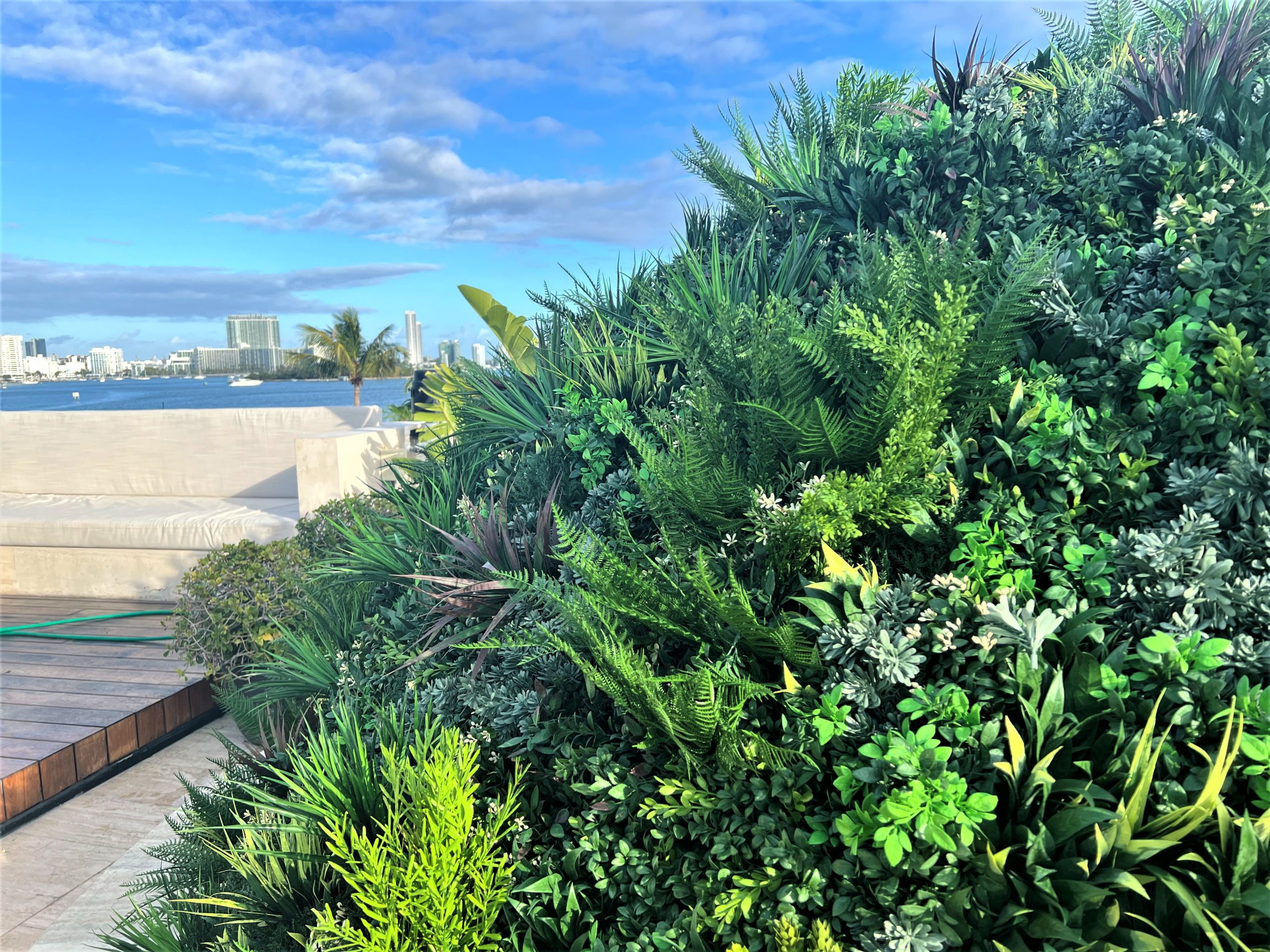an artificial living green wall installation by Vistafolia in Miami