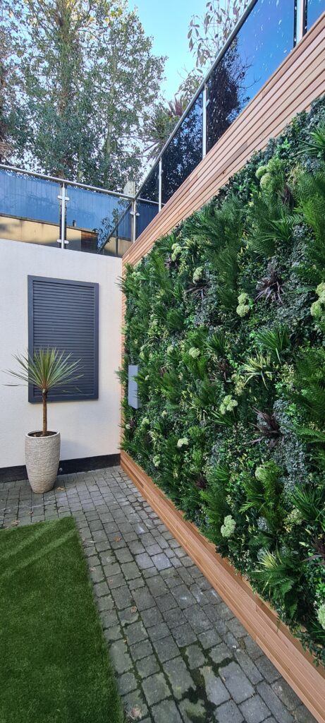 Garden faux green wall installation by Vistafolia